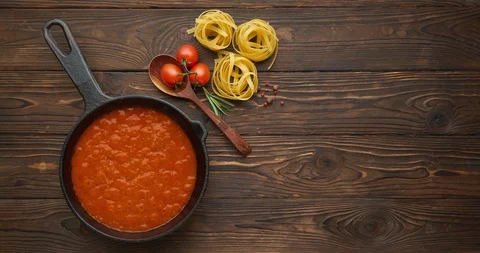 Cinemagraph loop. Bubbling hot tomato sauce for pasta, cooking in a pan on Stock Footage 120607804