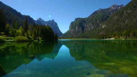 Cinemagraph loop of calm water rippling on Lake Dobbiaco with Monte Cristallo Stock Footage 342354198