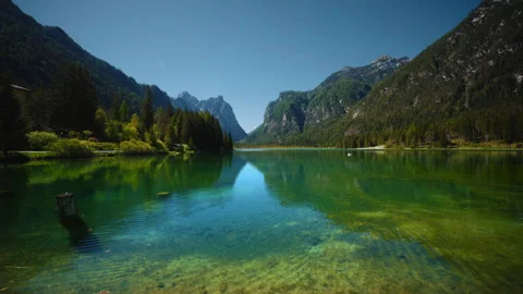 Cinemagraph loop of calm water rippling on Lake Dobbiaco with Monte Cristallo Stock Footage 342354242