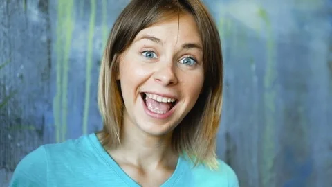 Cinemagraph loop of Charming cheerful blond hair female waves palm leaf Stock Footage 83386648