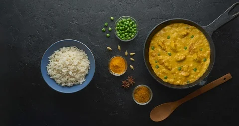 Cinemagraph loop. Cooking tasty chicken curry dish with rice in a cast iron pan Stock Footage 120607824