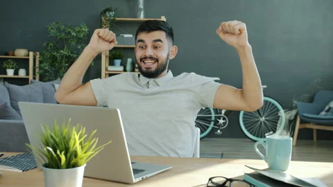 Cinemagraph loop of excited freelancer getting good news looking at laptop Stock Footage 132244334