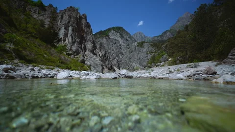 Cinemagraph loop of a fresh clear mountain river flowing past rugged peaks Stock Footage 340197140