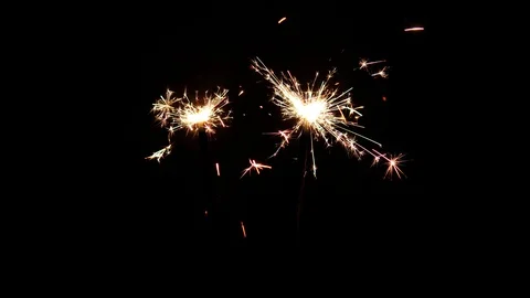 Cinemagraph loop. Two burning sparklers isolated on black. Holiday background Stock Footage 128953855