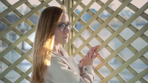 Cinemagraph. Loop video. Live photo. Blonde girl with glasses and flying hairs Video stock 141285044