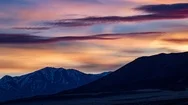 Cinemagraph Of Magenta Clouds Colored By The Setting Sun Pass Over  Stock Footage