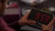 Cinemagraph Of Man Holding A Digital Clock And Looking At The Time Passes  Stock Footage