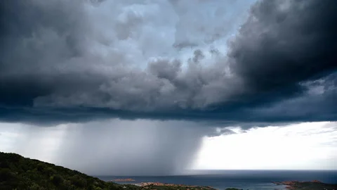 Cinemagraph motion loop of Beautiful dark large stormy clouds over hills and sea Video stock 151863482