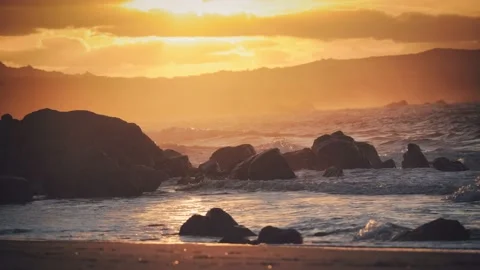 Cinemagraph motion loop of red orange  sunset on wild beautiful beach and sea Stock Footage 151711711