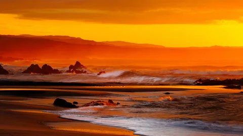Cinemagraph motion loop of red orange sunset on wild beautiful beach and sea Video stock 151799143