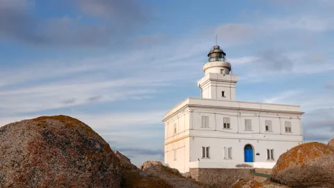 Cinemagraph motion loop shot of beautiful lighthouse between rocks Stock Footage 153110761