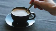 Cinemagraph Of Person Mixing Sugar In Coffee Cup Stock Footage