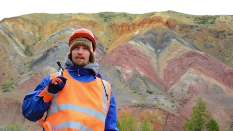 Cinemagraph - Portrait of a mining engineer, a geologist in the protective Stock Footage 83497230