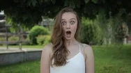 Cinemagraph Of Pretty Cute Young Woman Surprised Shocked On Green Trees Stock Footage