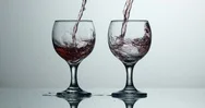 Cinemagraph Red Wine Pours Into Glass While Other Is Frozen Stock Footage