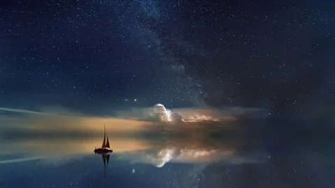 Cinemagraph of sailboat on ocean stary night with clouds Stock Footage