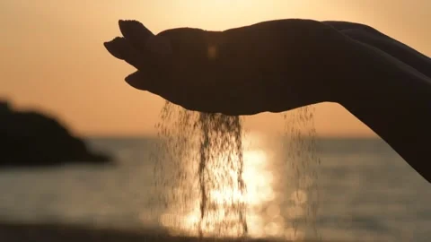 Cinemagraph - Sand running through a woman's hands. Stock Footage 90779069