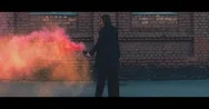 Cinemagraph - Seamless Loop. Caucasian Girl Standing With A Red Color Smoke Bomb Stock Footage