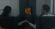 Cinemagraph - Seamless Loop. Couple Sits Near The Fireplace, Holding Hands Stock Footage