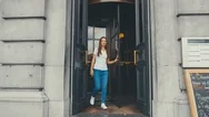 Cinemagraph - Seamless Loop. Girl Walks Out Of A Building With Revolving Doors Stock Footage