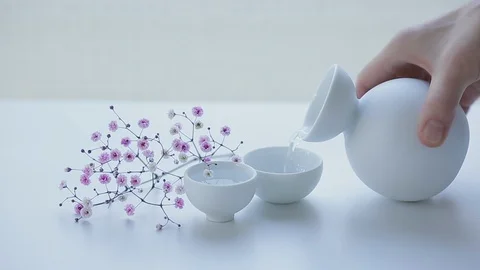 CINEMAGRAPH - seamless loop. Japanese sake is poured into ceramic glass. Stock Footage 95898705