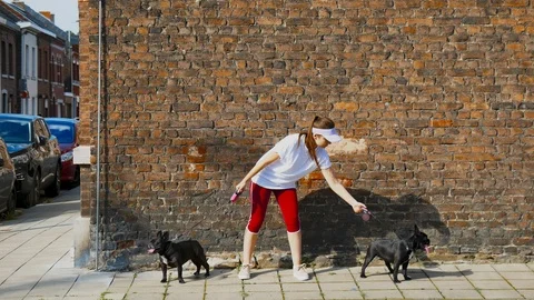CINEMAGRAPH - SEAMLESS LOOP. Portrait of young Caucasian girl holding 2 black fr Stock Footage 90328787
