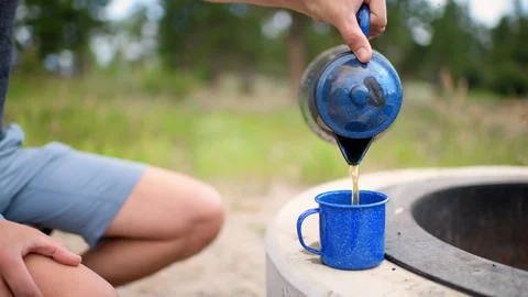 Cinemagraph seamless loop of pouring tea from teapot campground in morning Stock Footage 130072906