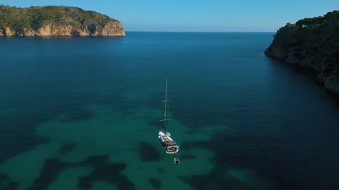 Cinemagraph seamless video loop of beautiful beach with boat, sailing Stock Footage 240689331