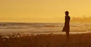 Cinemagraph - Silhouette Man Standing Ocean Beach Waves Sunset 4K Motion Photo Stock Footage