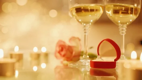 Cinemagraph - Two glasses with white wine and rose flower on bokeh background. Video stock 92020397