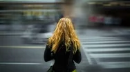 Cinemagraph Of Woman Standing On Busy Street Corner Stock Footage