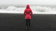 Cinemagraph Of Woman Wearing Red Coat On Beach Stock Footage