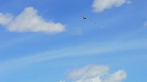 Cinematic 4K Drone Tracking Shot of a Single Colorful Kite Flying in the Sky Stock Footage 334550669