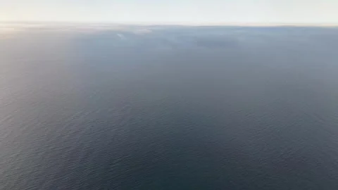 Cinematic 4K Right to Left Aerial Pan of Foggy Ocean During Golden Hour Stock-Footage 334327043