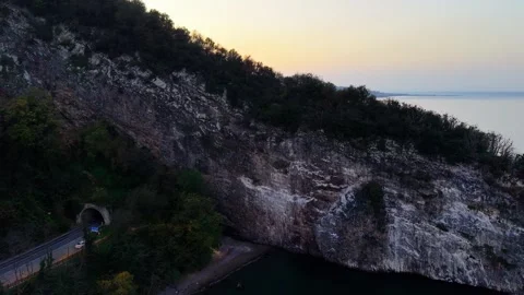 Cinematic 4K Sunset Drone View, Moving Back from Tunnel and Island Stock-Footage 334327874