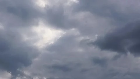 Cinematic 4k timelapse of stormy clouds with sunlight dancing in between 動画素材 343617698
