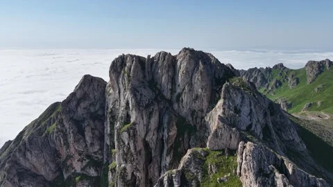 Cinematic 4K UHD Drone Flight Over Rugged Rocky Mountains Above a Sea of Clouds. Stock Footage 342066366