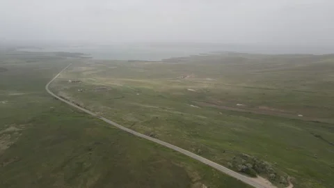 Cinematic aerial drone flyback over foggy lake and countryside road Stock Footage 337456407