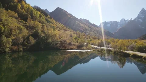 Cinematic aerial drone view of alpine lake in autumn morning sun Stock Footage 337528587