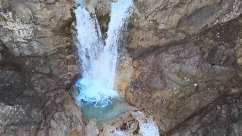 Cinematic aerial drone view of a powerful mountain waterfall Stock Footage 337538120