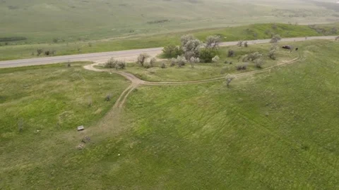 Cinematic aerial flight over an empty countryside road and remote wilderness Stock Footage 337456457