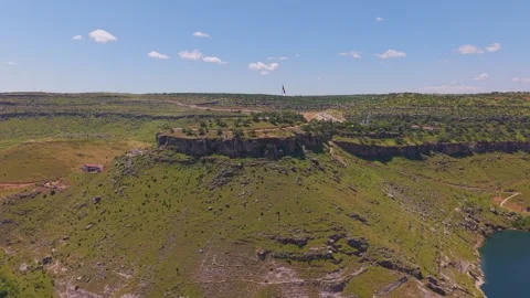 Cinematic Aerial Flight Toward a Dramatic Canyon Summit Above the River Stock Footage 341004412