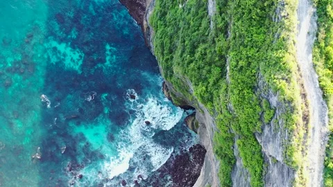 Cinematic aerial footage top view of vertical rock cliff. Drone flying forward Stock Footage