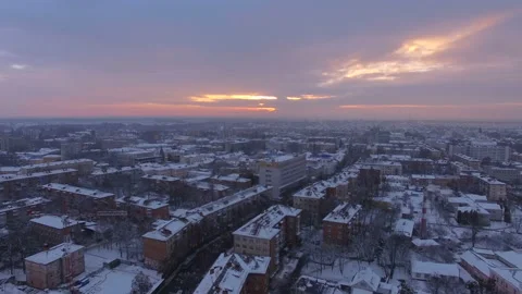 Cinematic aerial panoramic shot rising above small town at sunset Stock Footage 113684471