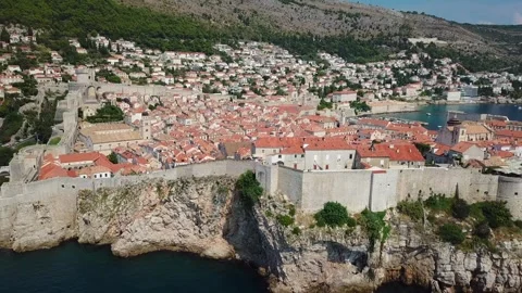 Cinematic Aerial Pull-Back Reveal of Dubrovnik Old Town Walls and Adriat Stock Footage 323311071