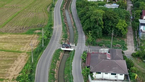 Cinematic aerial top-down view of a car crossing a bridge in Asia Stock Footage 335417905