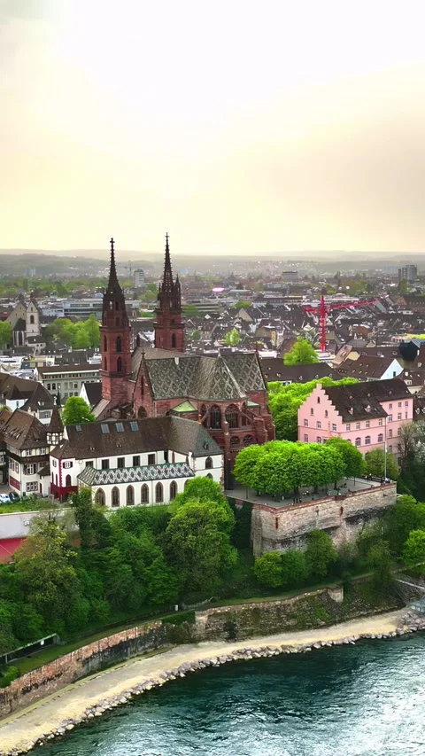 Cinematic aerial view of Basel Minster cathedral and Rhine river at sunset .. Stock Footage 339441110