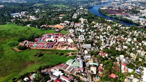 Cinematic aerial view of a container yard in Aluva featuring colorful stacked Stock Footage 336563359