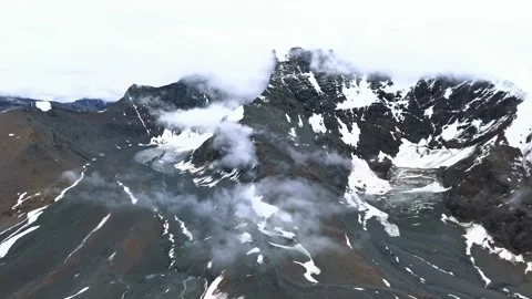 Cinematic aerial view of dramatic mountain peaks with mist and snow. Stock-Footage 341136967