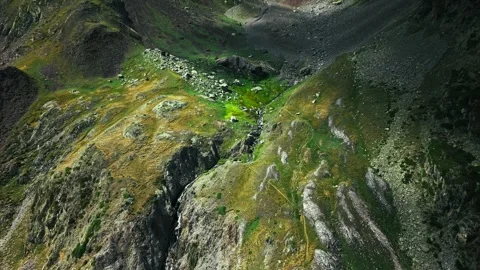 Cinematic aerial view of dramatic rocky mountain amphitheater with shadows Stockbeeldmateriaal 344652119